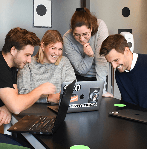 people gathered around laptop